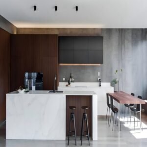 “Modern minimalist kitchen cabinet with a bright white island, dark upper units, warm wood accents, and flat-panel fronts—clean lines and seamless design for a calm, elegant kitchen space.”