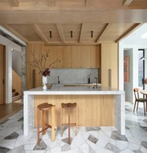 High-quality wooden kitchen cabinetry with smooth finishes and visible natural wood grain, featuring coordinated upper and lower cabinets that create a warm, inviting, and elegant kitchen atmosphere.