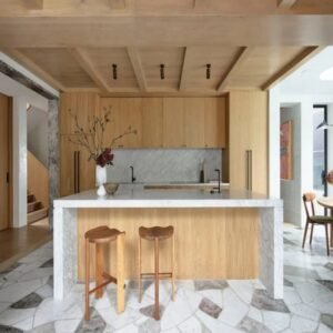 High-quality wooden kitchen cabinetry with smooth finishes and visible natural wood grain, featuring coordinated upper and lower cabinets that create a warm, inviting, and elegant kitchen atmosphere.