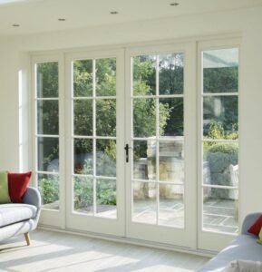 Classic cottage cream lattice French doors with garden view and stainless steel hardware