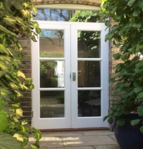 Vintage cottage buttercream lattice French garden entry doors with stainless steel hardware