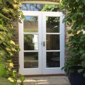 Vintage cottage buttercream lattice French garden entry doors with stainless steel hardware