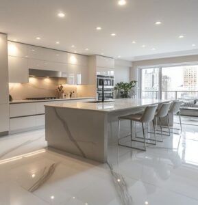 Modern minimalist kitchen with ivory MDF cabinets, a veined marble island, and stainless steel fixtures.