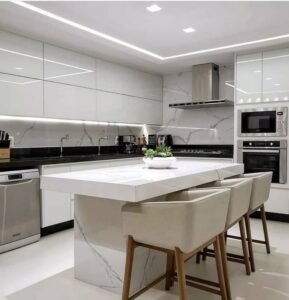 Light luxury kitchen with fiberglass glossy white cabinet set marble island and LED lighting.