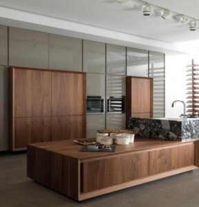 Kitchen with walnut solid wood kitchen cabinets and a stone-effect plywood island.
