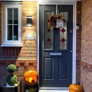 Cozy cottage slate blue opening door with stained glass panels