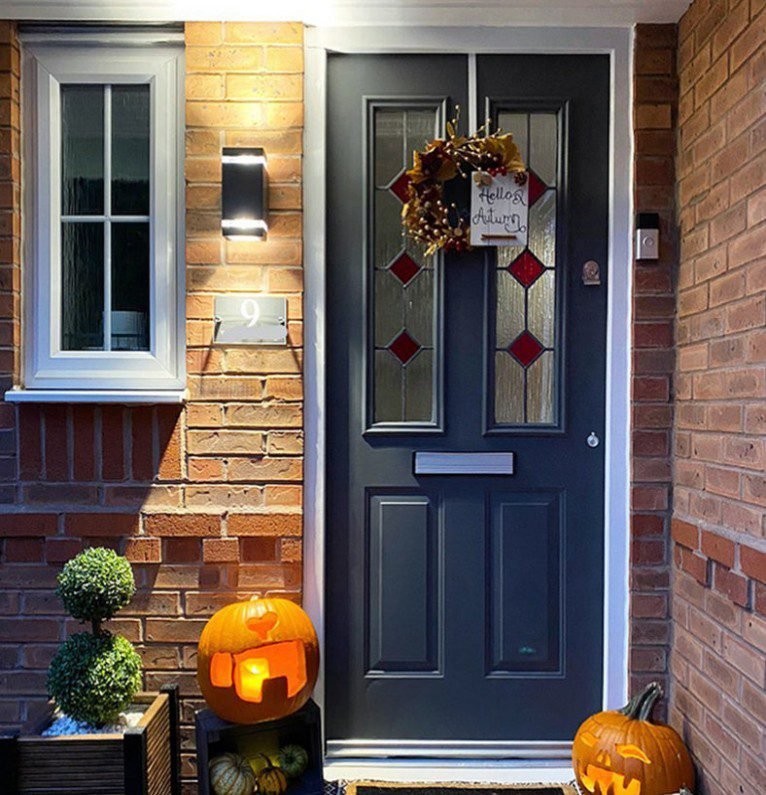 Cozy cottage slate blue opening door with stained glass panels