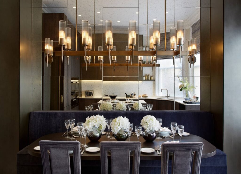 Sleek linear chandelier suspended above a long dining table, offering clean lines and balanced lighting for modern designs.