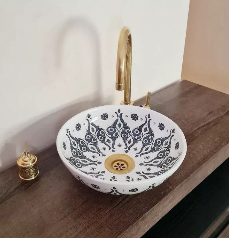 Patterned Ceramic Basin with Gold Faucet features intricate designs, gold accents, adds elegant charm to bathrooms with its refined ceramic build and stylish details.