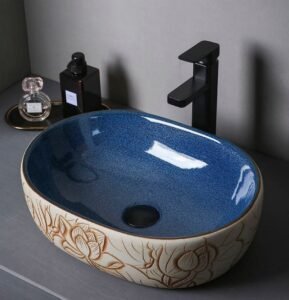 Lotus Carved Ceramic Basin boasts 3D carvings, dual-tone finish, creates oriental ambiance in bathrooms with its ceramic artistry and cultural details.