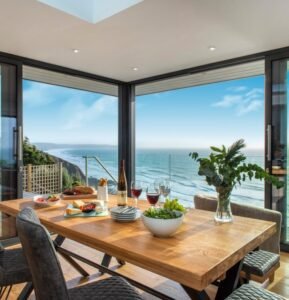 Oak Wood Luxe Coastal Dining Table features premium design, luxe style, crafted with fine oak, create opulent charm in ocean-view luxurious dining spaces.