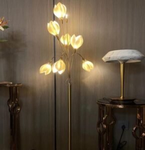 Adorned with golden magnolia flower designs, this floor lamp emits soft warm light, bringing a romantic elegant touch to classic or luxury living spaces.