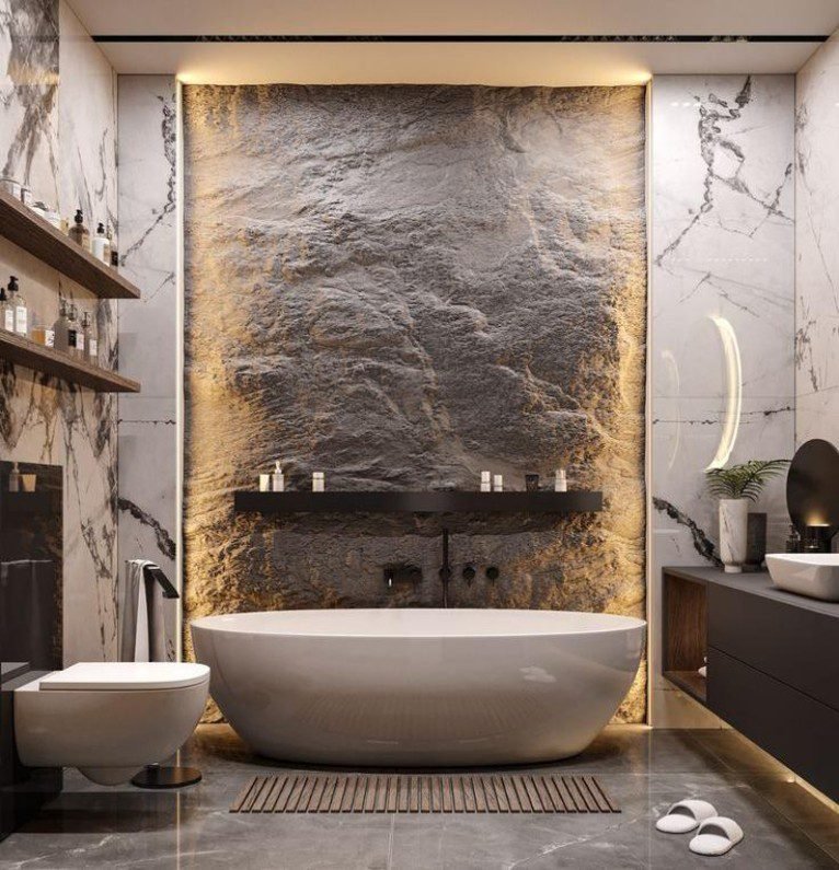 White Stone Bathtub displays sleek design, light finish, creates chic ambiance in modern bathrooms with its marble backdrop and elegant details.