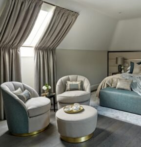 Two-tone Luxe Swivel Chairs boast gold accents, plush fabric, add opulent charm to elegant bedroom spaces with their swivel functionality.