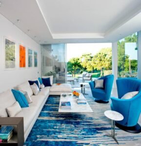 Blue Luxe Swivel Chairs boast rich fabric, bold design, create lavish ambiance in luxe living spaces with their swivel functionality.