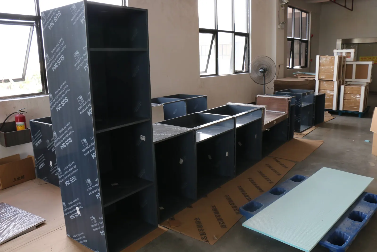 Cabinet carcasses being checked during assembly