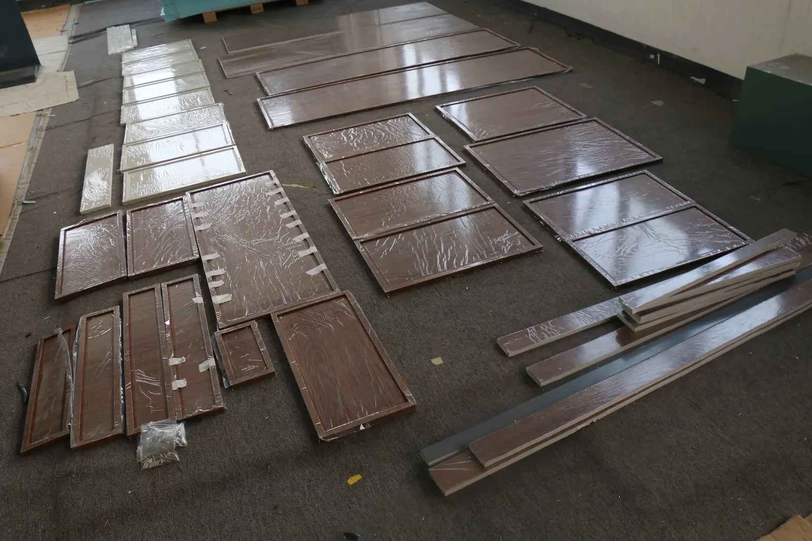 Cabinet doors and components laid out for quality inspection