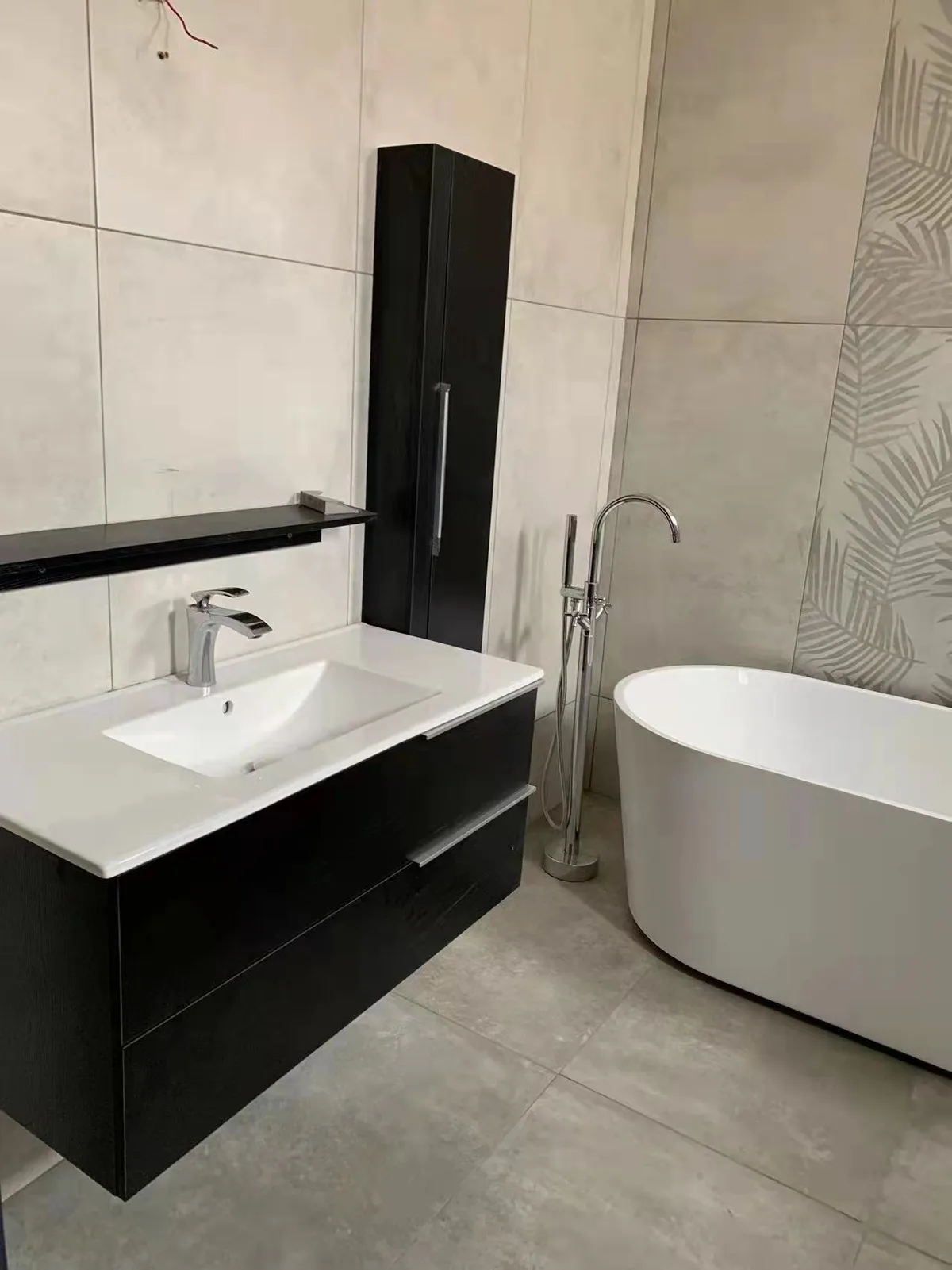 Finished bathroom with a freestanding tub and black vanity