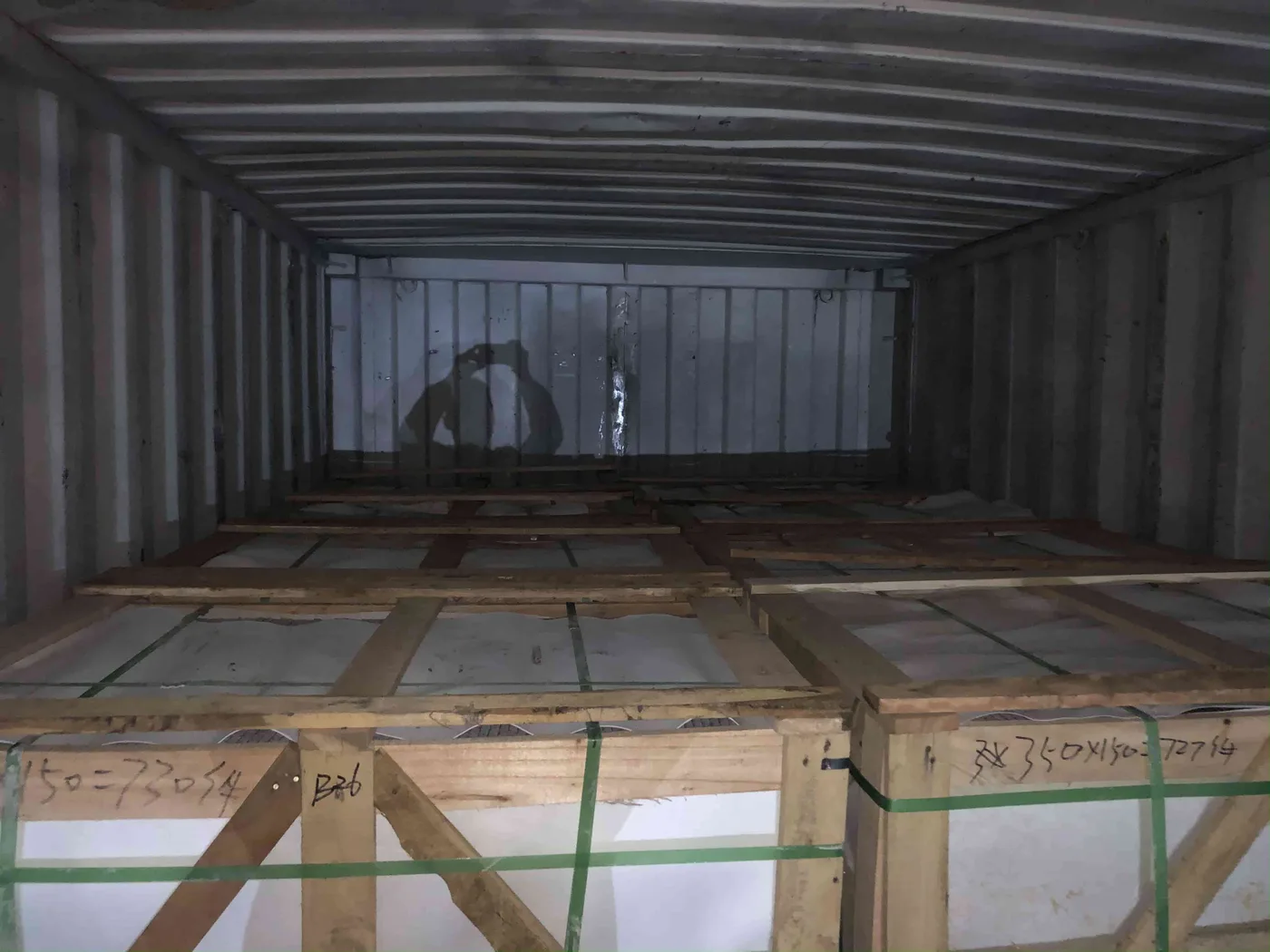 Wooden crates of marble tiles loaded into a shipping container
