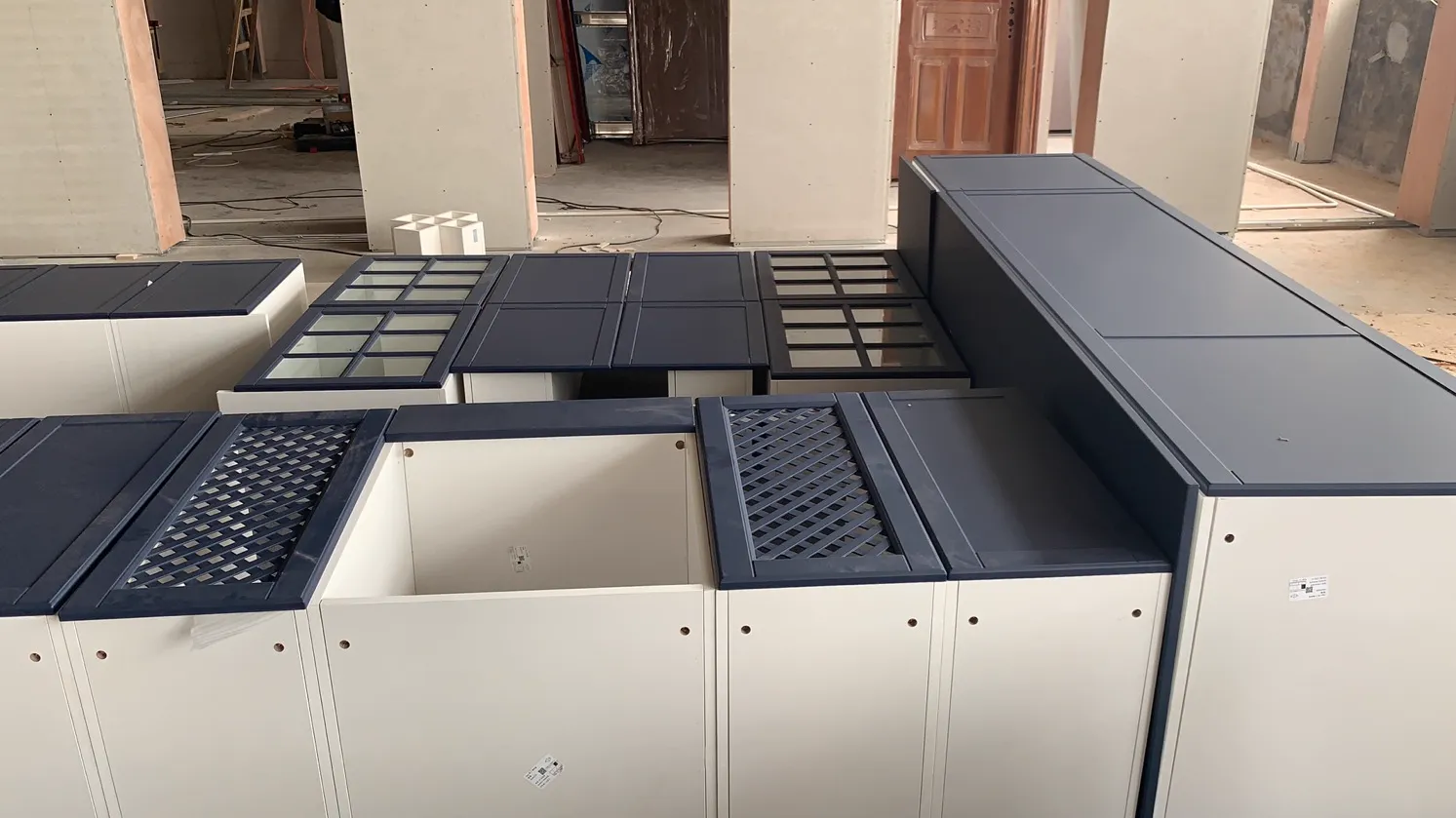 George Group blue-grey Shaker kitchen cabinets during factory pre-assembly