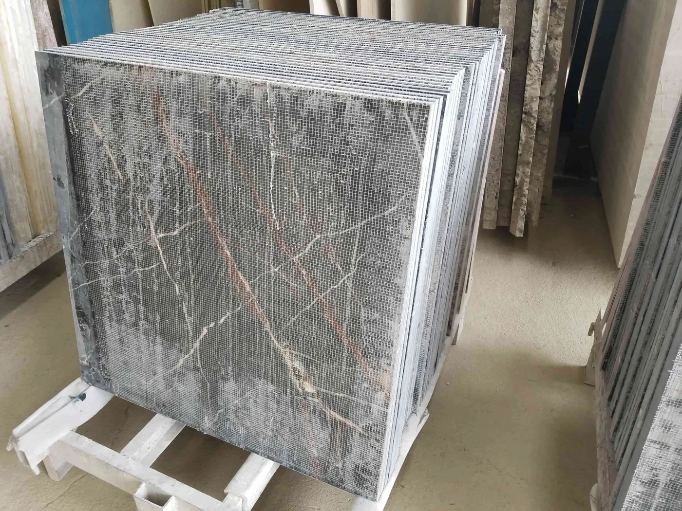Dark marble slabs with mesh backing prepared for transport