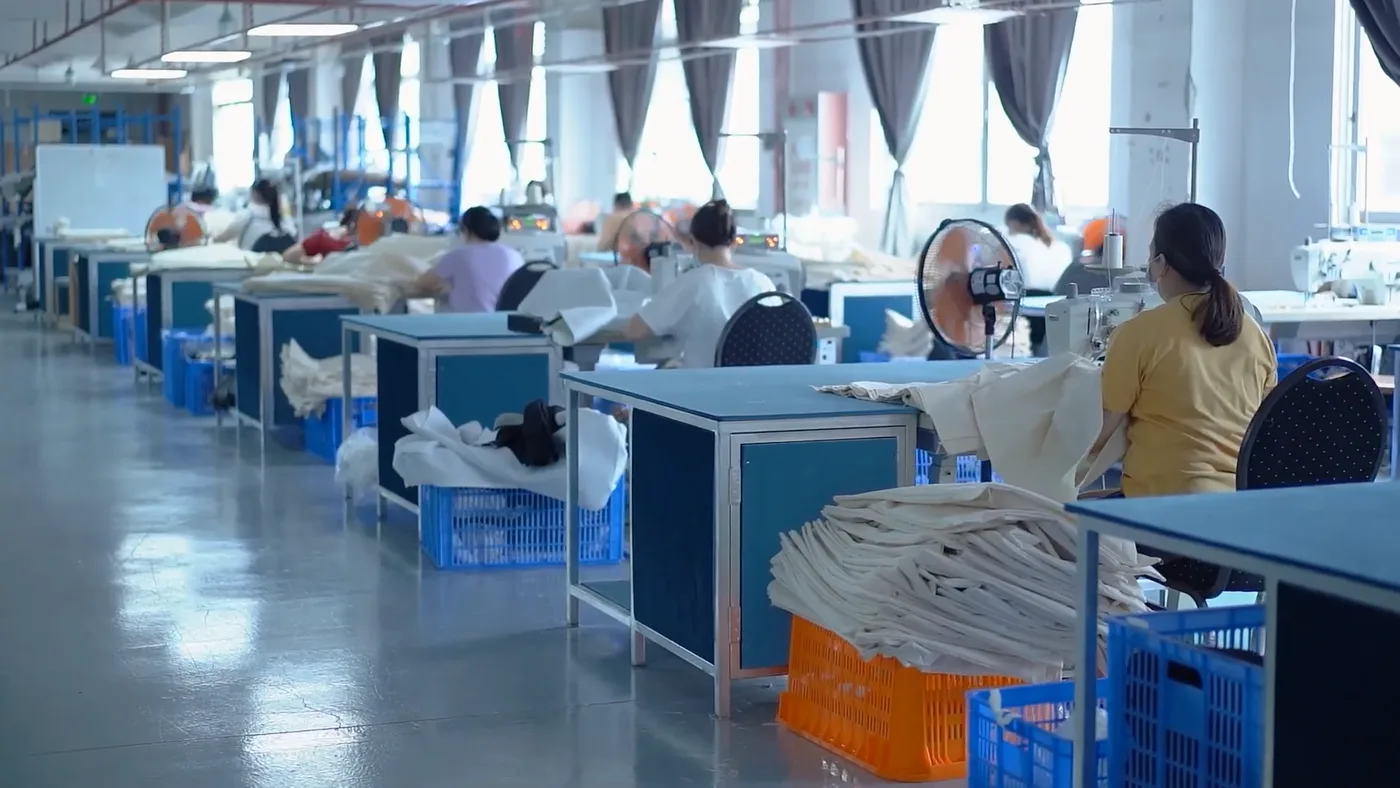 Textile production floor with workers at sewing stations