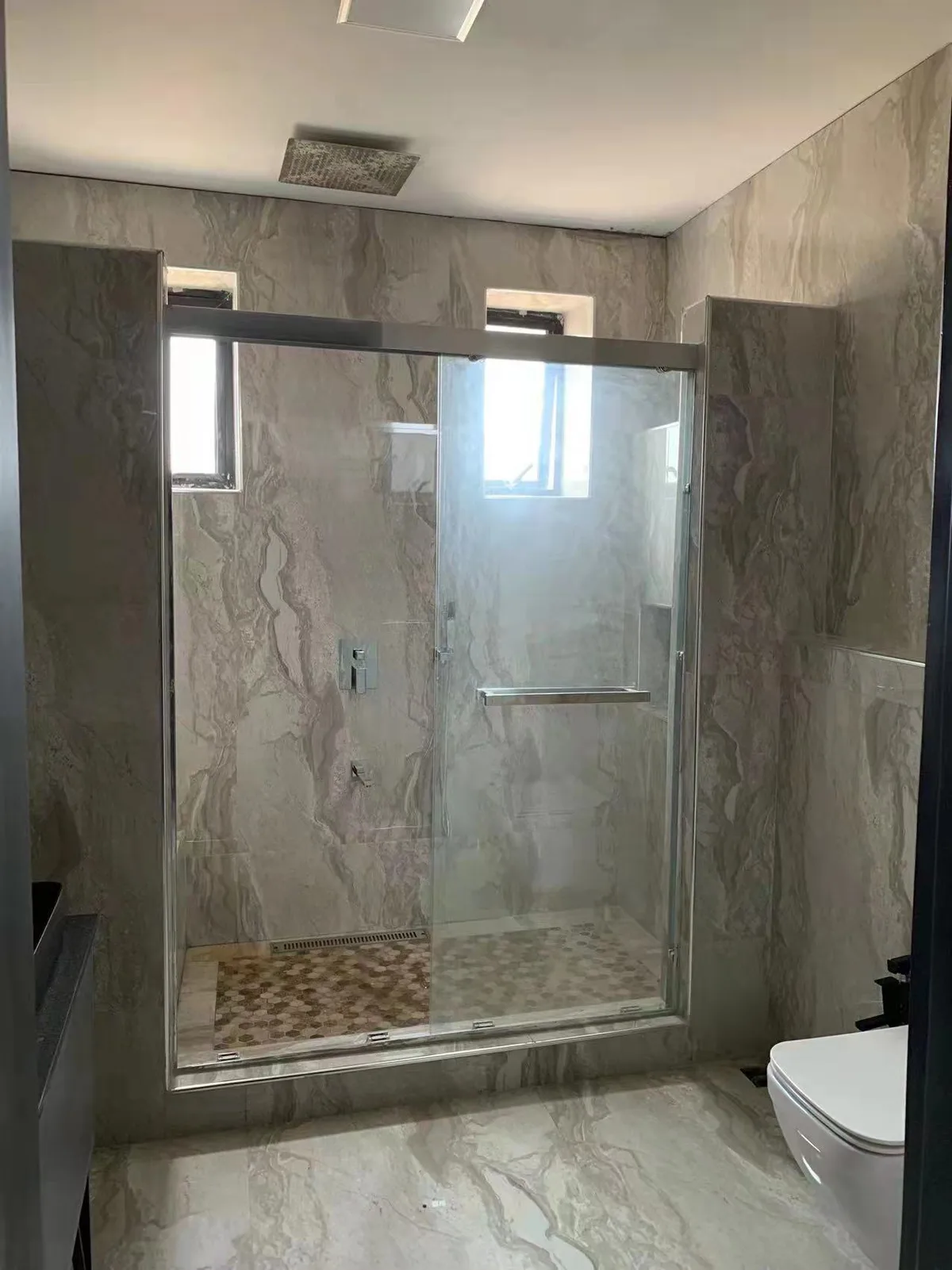 Glass shower enclosure in a finished bathroom
