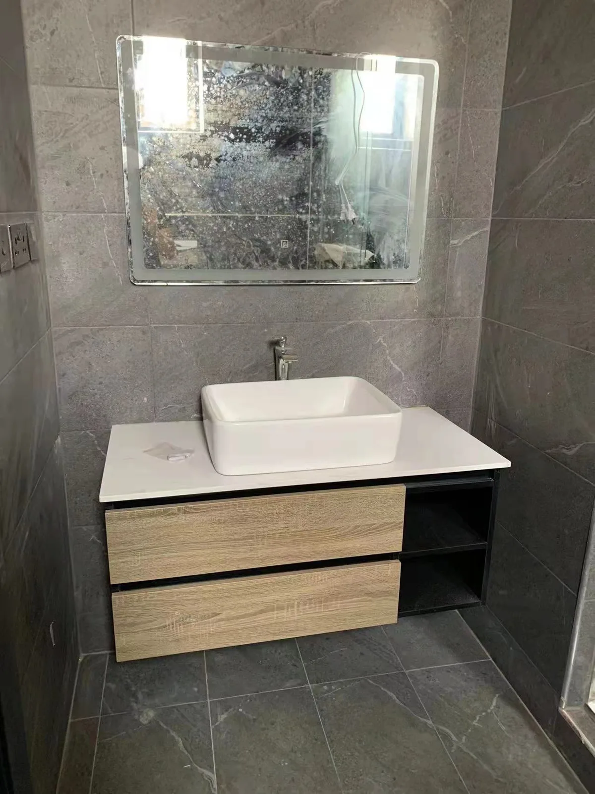 Wood-front vanity with vessel basin and mirror cabinet