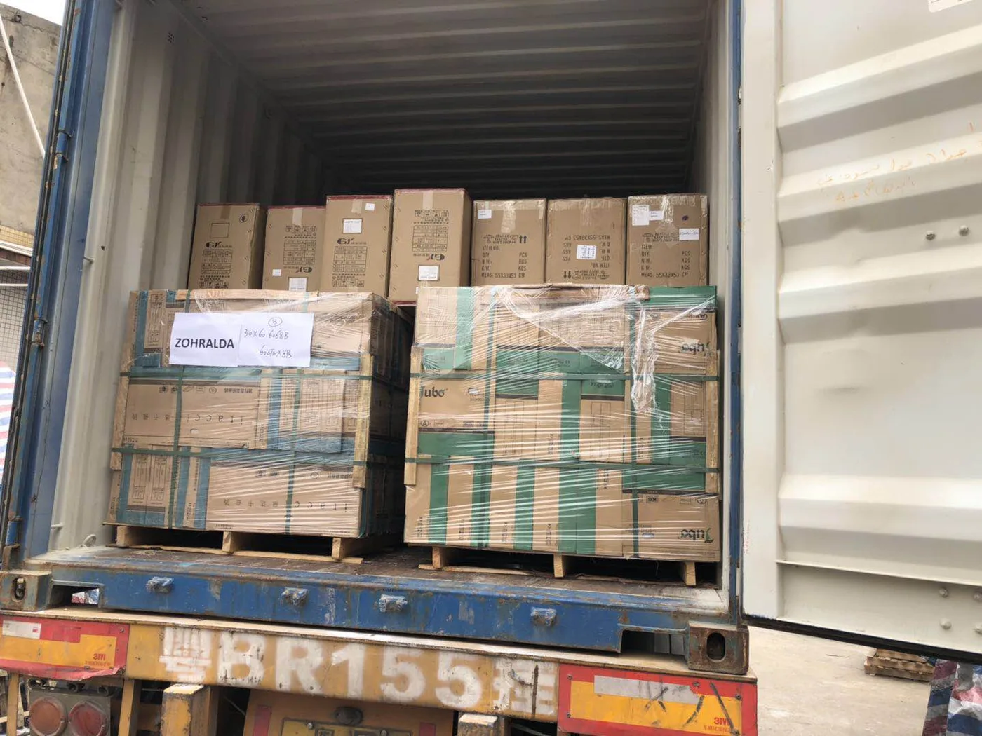 Pallets of lighting cartons loaded into a shipping container