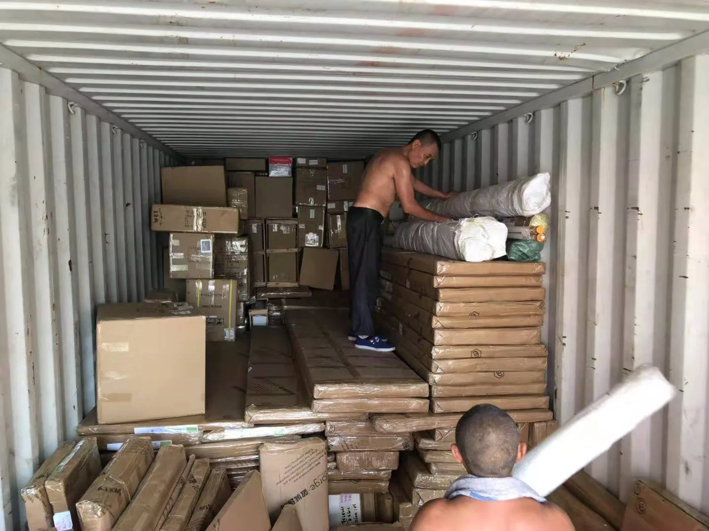 Tile cartons and pallets being loaded into a shipping container