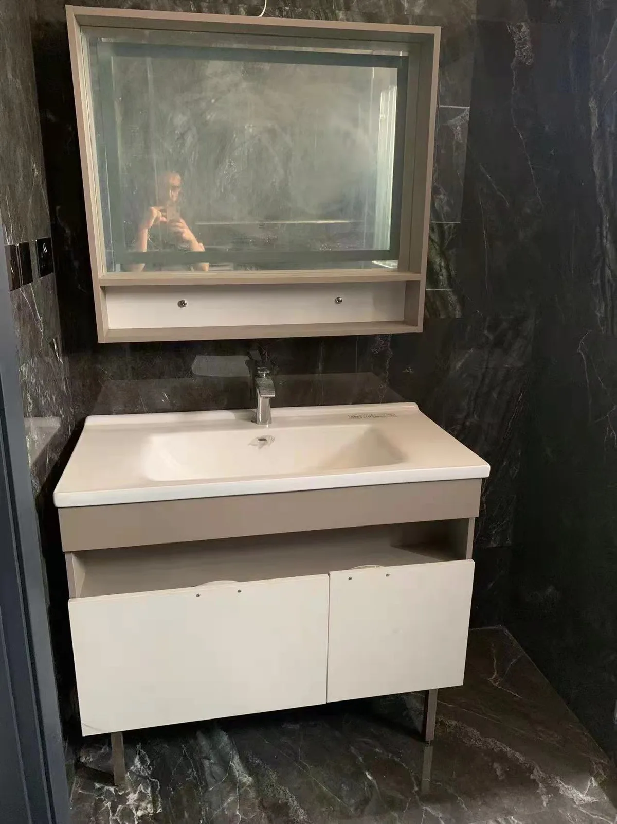 Bathroom vanity with mirror cabinet and basin on display