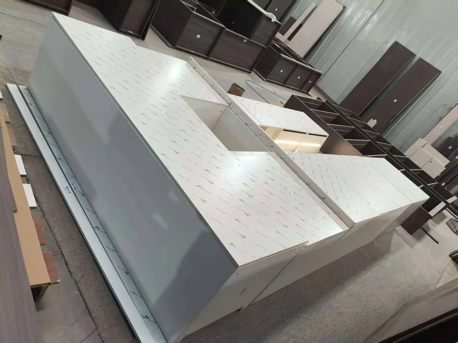 Custom cabinets in protective film during pre-shipment QC for a villa project in Ghana